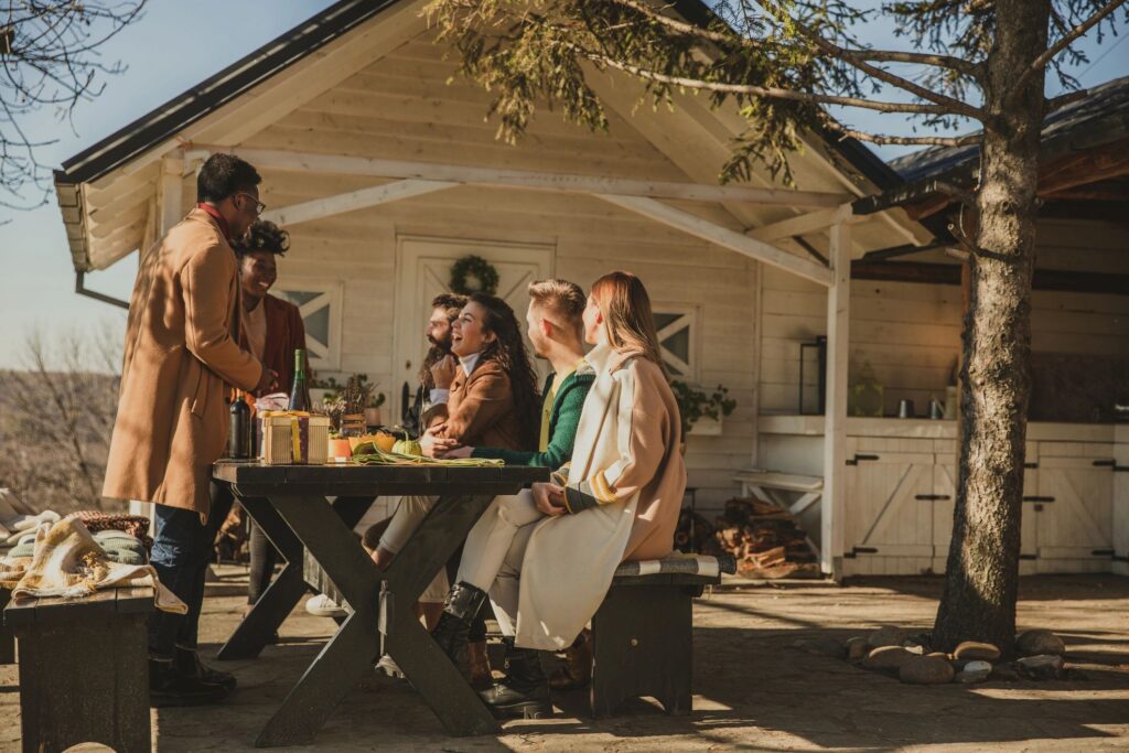 Group of people, friends, having fun and hanging out in warm autumnal sunshine